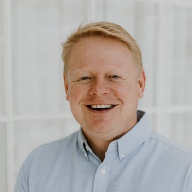 Portrait of Jonathan Kollmann, the Pastor of Connections at Anderson Hills Church, smiling