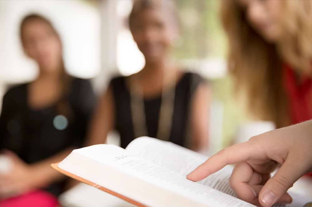 Focused study session with participants reading the Bible together at Anderson Hills Church