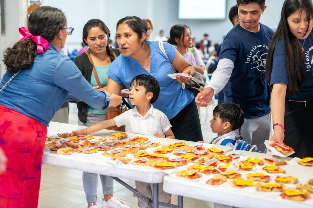 Families in Church picking up food from table