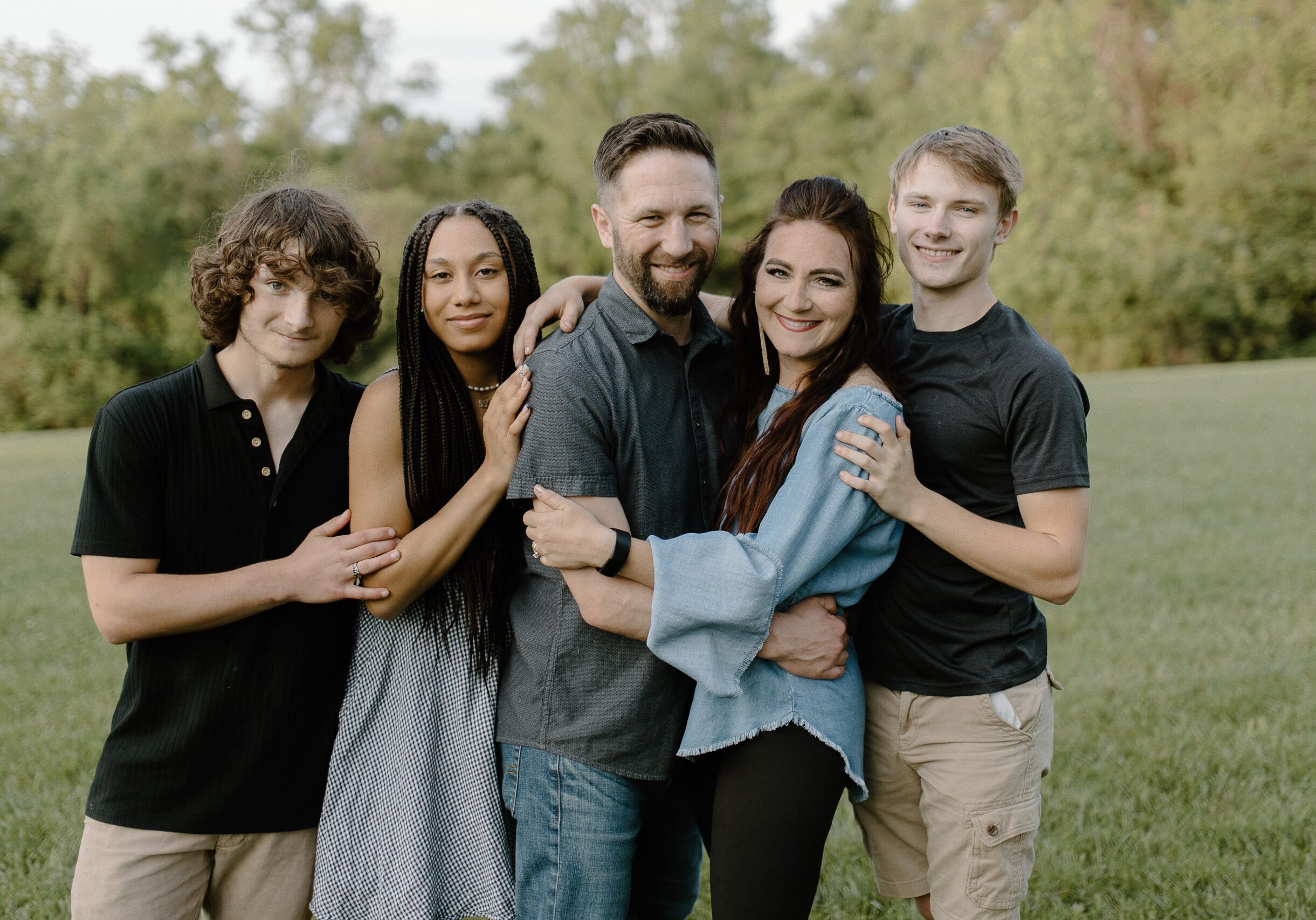 Pastor Jon Ferguson and his family posing happily outdoors